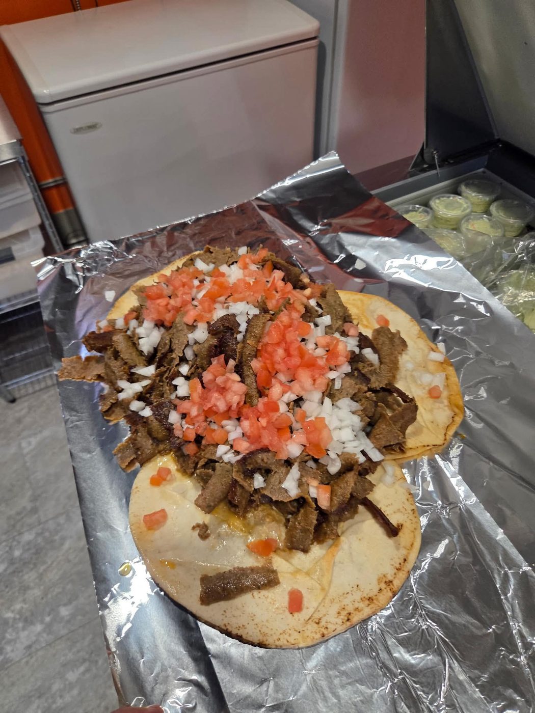An open-faced Old School donair piled with spiced donair meat, fresh onion and tomato